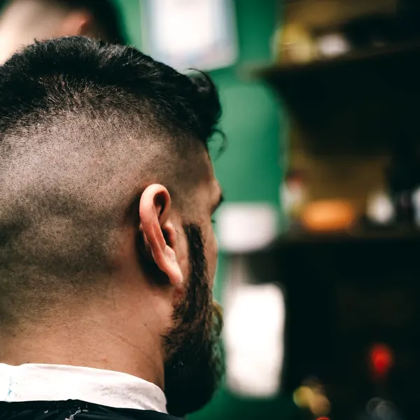 Back of the head showing a skin fade blended into a beard